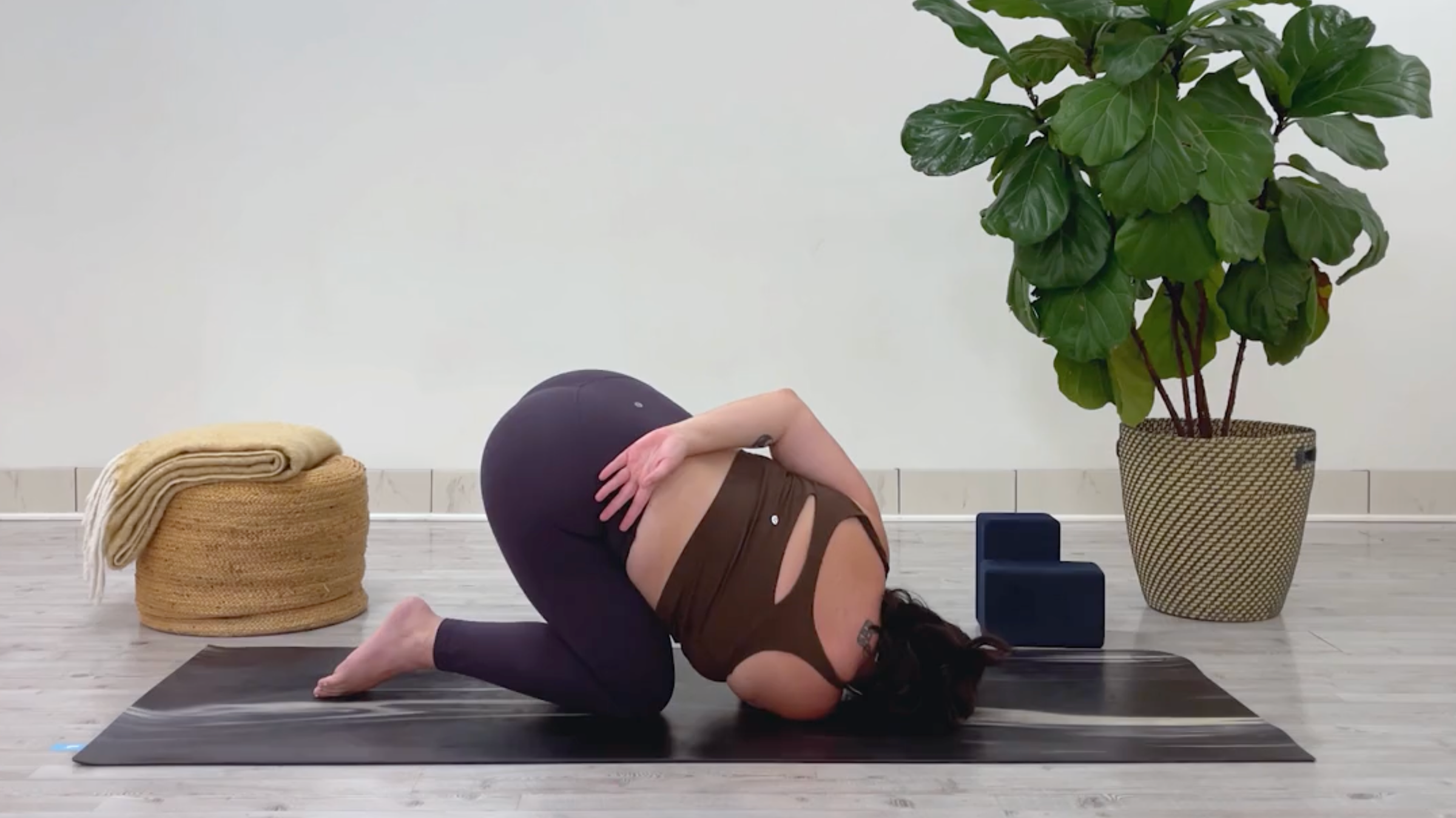 Yoga teacher Taylor Lorenz in Thread the Needle, part of her 10-minute cool down yoga routine
